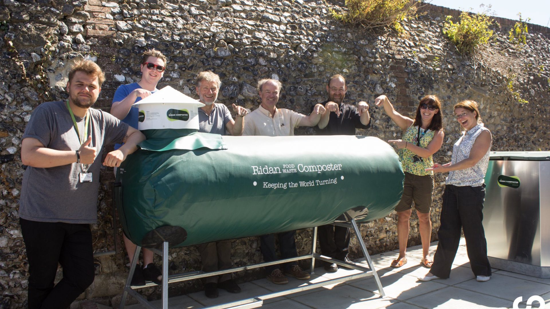 group of people stood around a Ridan composting machine